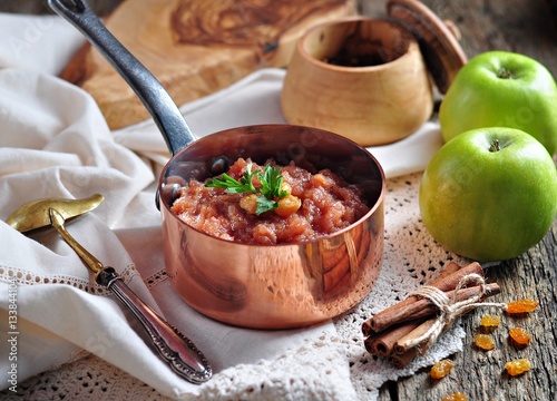 Фотография Homemade apple chutney with raisins, cinnamon, chili and other spices
