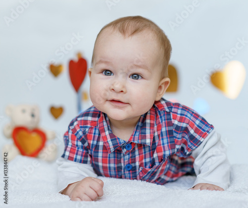 Valentine's day baby lying on white background and hearts