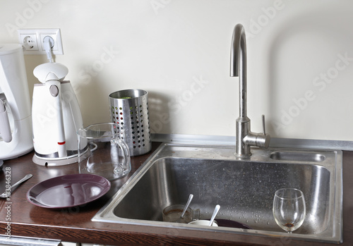 Dirty dishes in a kitchen sink photo