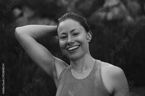 Black and white portrait of woman holding hair after swim