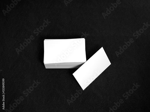 Stack of white business cards. Namecards mockup template on black leather background. 3D Rendering © flixelhouse