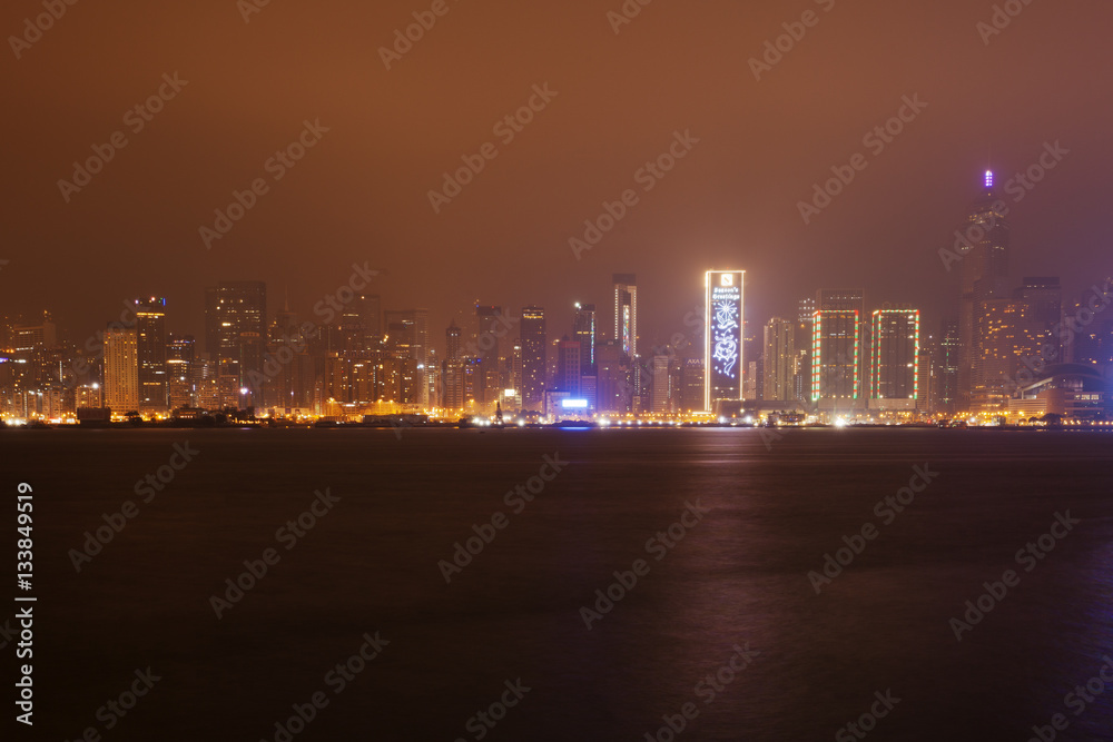 Buildings near the harbor bay in Hong Kong at night