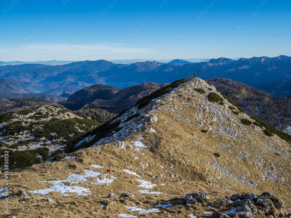 The mountaineer at the top of the mountain in Julian-Alps in Triglav national park, Slovenia