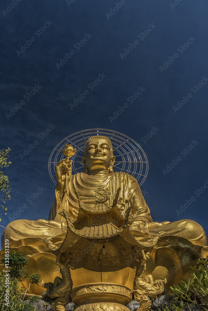Gold statue of sitting Buddha Gold statue of sitting Buddha