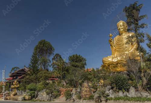 Gold statue of sitting Buddha photo