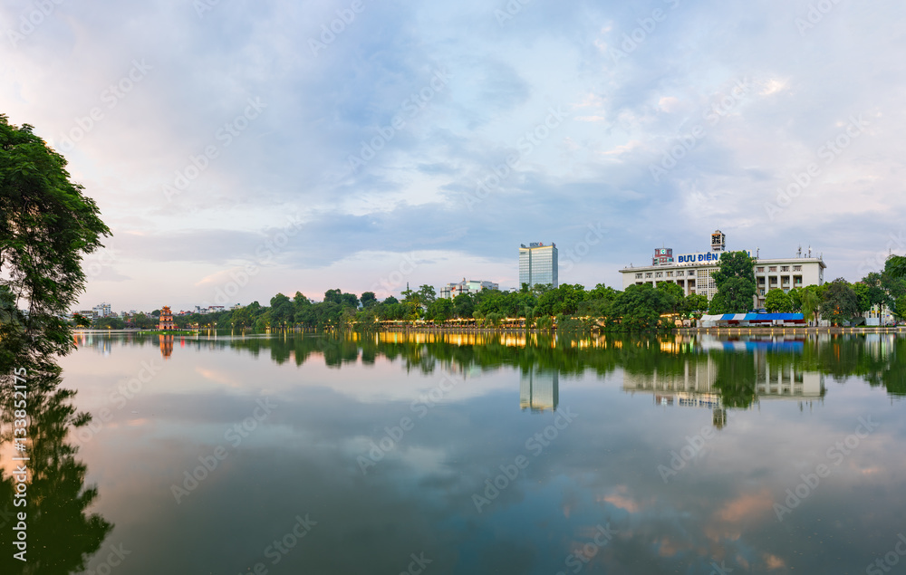 Hoan Kiem lake panorama view at sunset period with ancient Turtle Tower and Hanoi post office (Buu Dien Ha Noi in Vietnamese) . Hoan Kiem lake (Sword lake or Ho Guom) is center of Hanoi Hoan Kiem lake panorama view at sunset period with ancient Turtle Tower and Hanoi post office (Buu Dien Ha Noi in Vietnamese) . Hoan Kiem lake (Sword lake or Ho Guom) is center of Hanoi