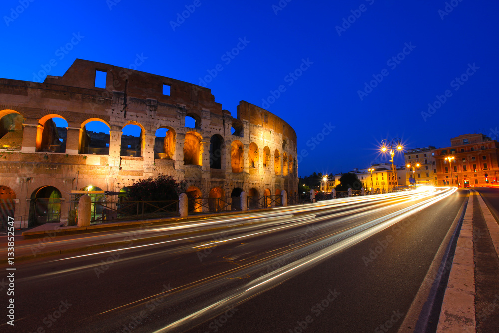 Colosseum and traffic light trails at twilight in Rome