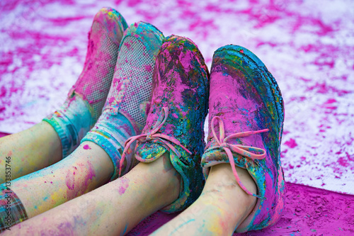 The colorful shoes and legs of teenagers with purple color powder in the public event The Color Run photo