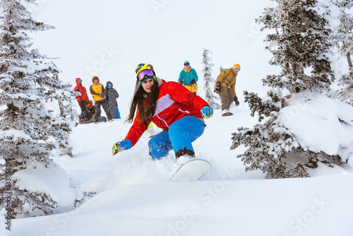 Girl snowboarder team group friends off-piste