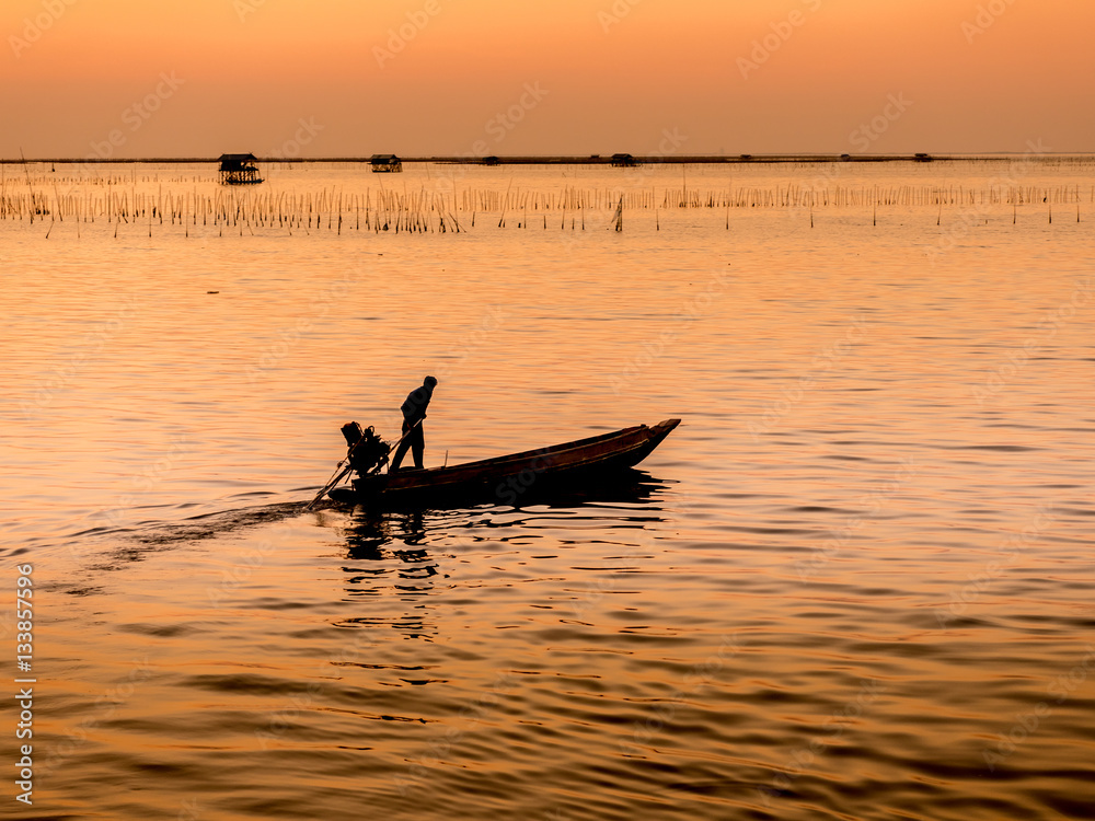 Naklejka premium Fishing boat coming back home , sunset light