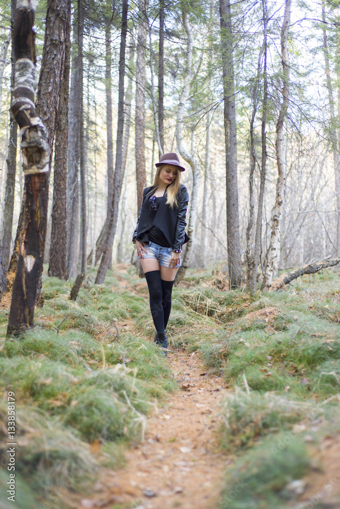 Beautiful young girl walking in the autumn forest. Beautiful young girl walking in the autumn forest.