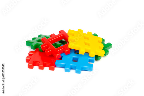 Heap of colorful plastic building blocks isolated on white