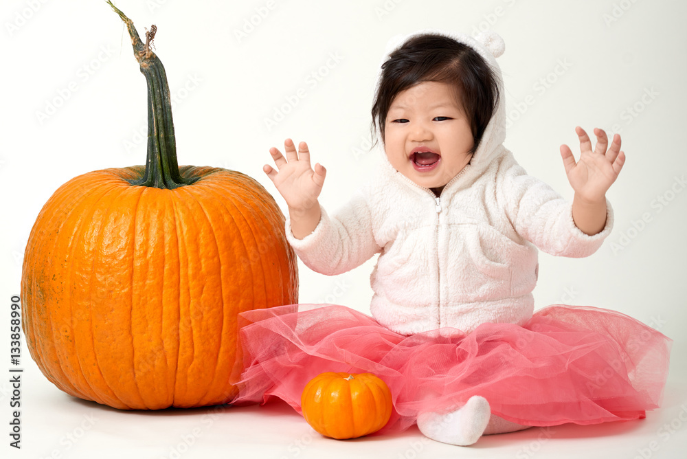Halloween happy & cute baby girl loves the giant pumpkins Halloween happy & cute baby girl loves the giant pumpkins