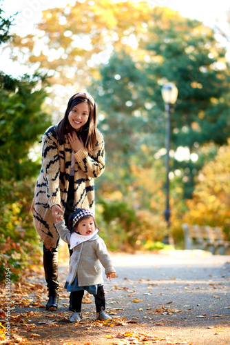 Mother holding daughter in stunning fall scene