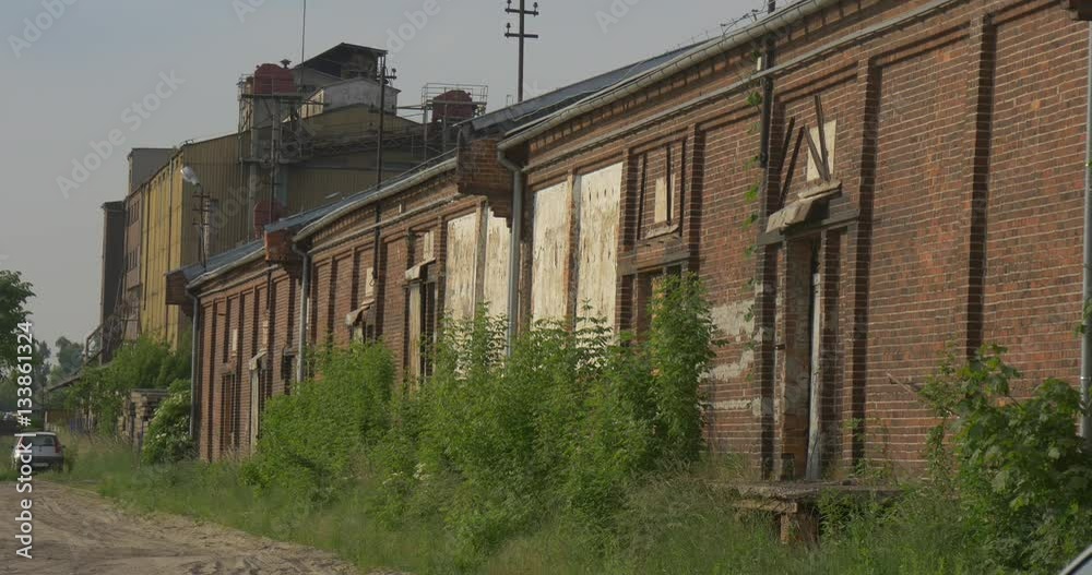 Old Brick Wall of Factory Abandoned Building Car is Parked Dull Industrial Landscape Sunny Evening Structures of the Plant Among Green Trees Cloudy Sky Old Brick Wall of Factory Abandoned Building Car is Parked Dull Industrial Landscape Sunny Evening Structures of the Plant Among Green Trees Cloudy Sky