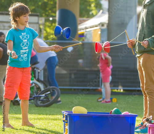outdoor portrait of young boy playing with diabolo, chinese yo-y