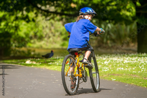 young happy preteen child boy riding a bicycle on natural park b © Alena Yakusheva