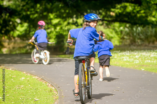 young happy preteen child boy riding a bicycle on natural park b