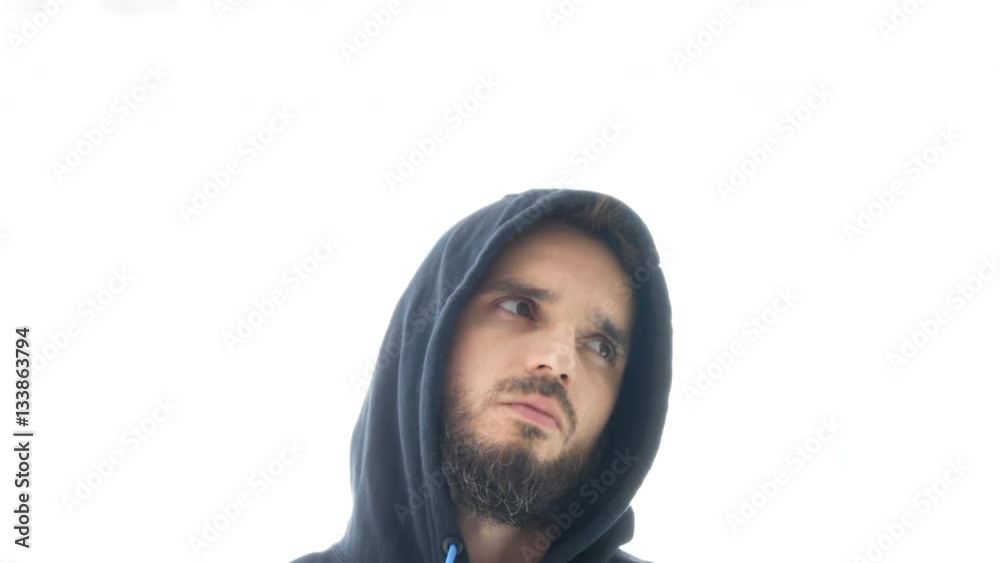 Serious self-confident bearded man in hoodie nodding his head in hip-hop beat, isolated on white background. Serious self-confident bearded man in hoodie nodding his head in hip-hop beat, isolated on white background.