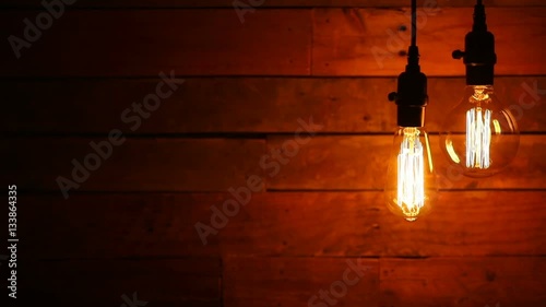   this is a video of old vintage hanging light bulbs against a retro urban Wood pallet background. There's a lot of space for a copy.
