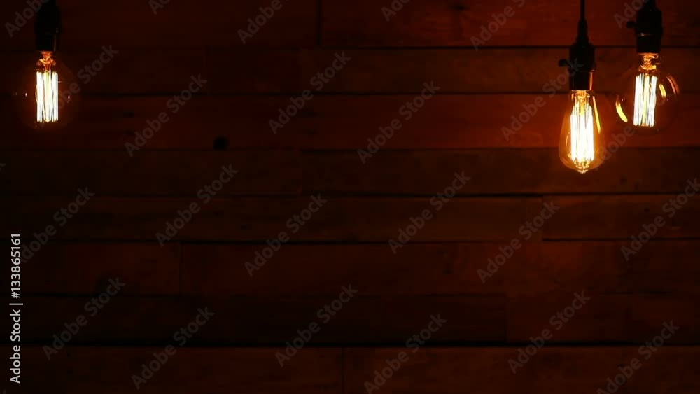   this is a video of old vintage hanging light bulbs against a retro urban Wood pallet background. There's a lot of space for a copy.
