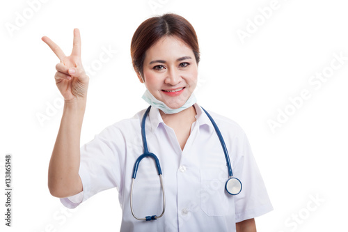 Young Asian female doctor show victory sign.