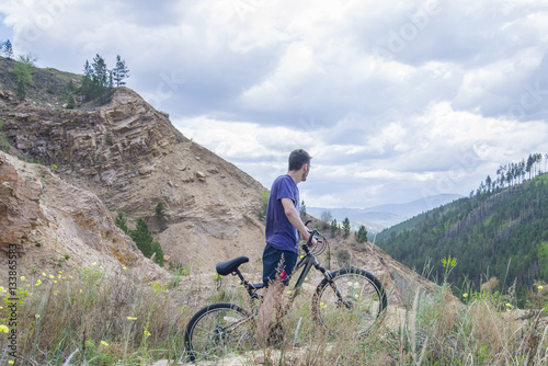 Young man on mountain bike in the mountains.