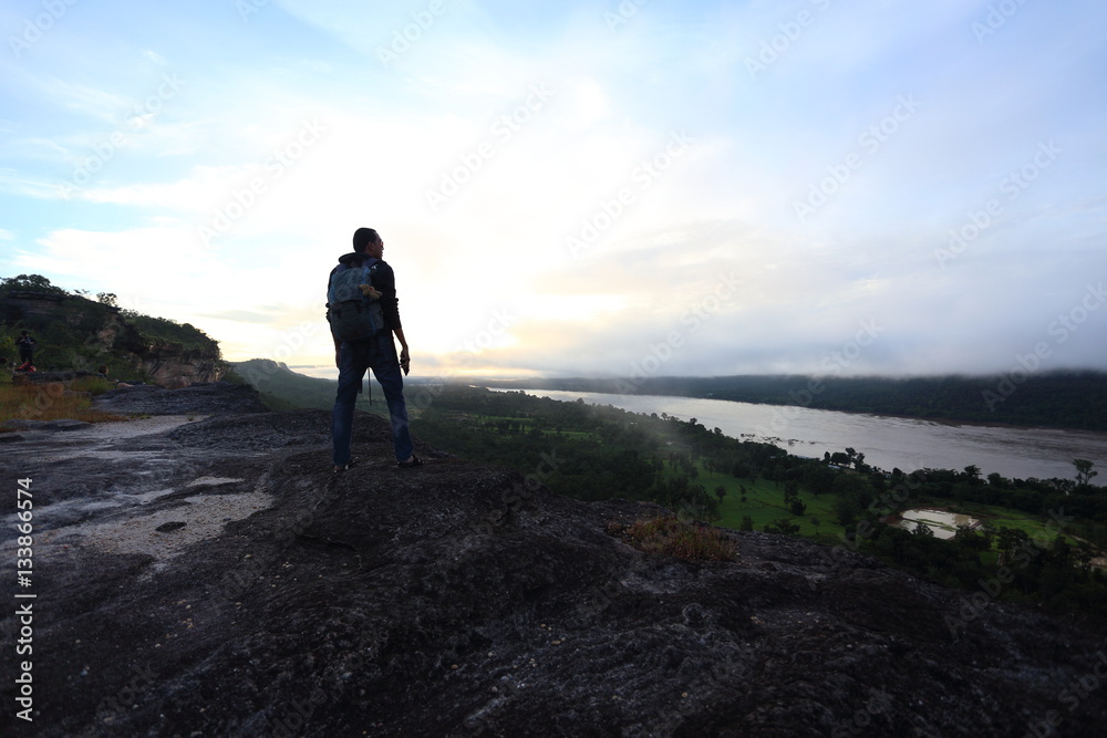 Man standing view mountains of Pha Taem National Park at Ubon Ratchathani, Thailand