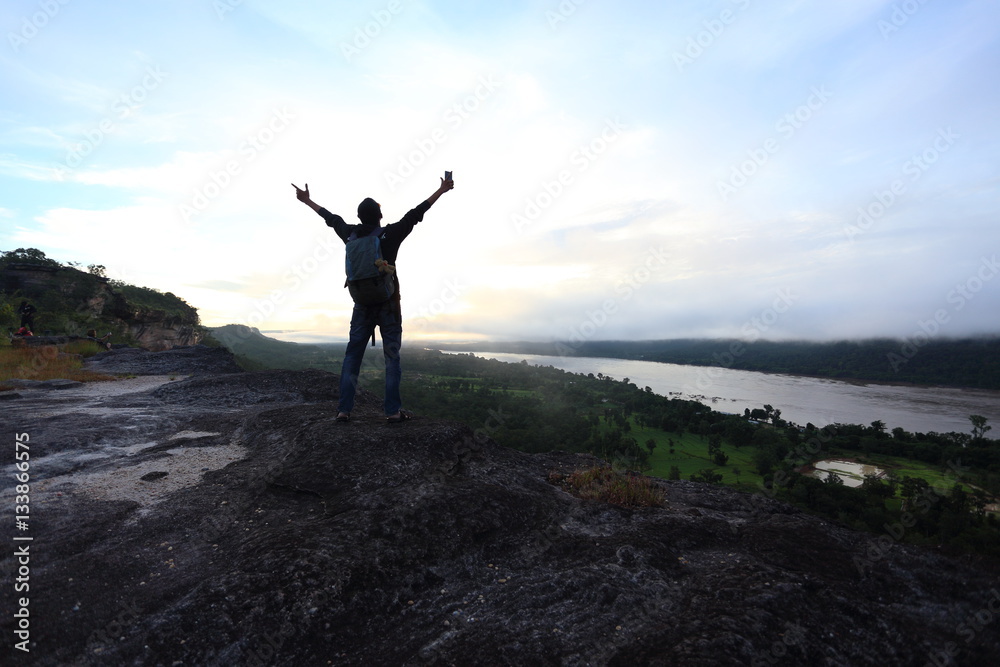 Man standing view mountains of Pha Taem National Park at Ubon Ratchathani, Thailand Man standing view mountains of Pha Taem National Park at Ubon Ratchathani, Thailand