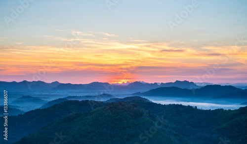 Beautiful sun was rising over the mountains with sky and cloud view from top mountain at Phu Bo Bit, Loei, Thailand