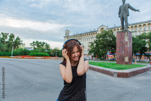 Asian girl listening to music with headphones photo