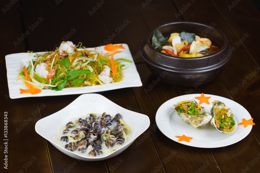Set of Asian seafood with grilled geoduck with onion and grease, Coconut Escargot, Shrimp stir-fried vermicelli, Spicy steam clam Set of Asian seafood with grilled geoduck with onion and grease, Coconut Escargot, Shrimp stir-fried vermicelli, Spicy steam clam