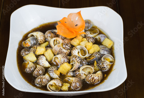 Stir-fried snail with tamarind, specialty food in Mekong delta, Vietnam. Asian food photo