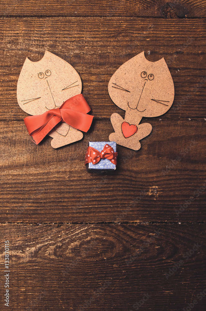 Two wooden cat with a red bow Two wooden cat with a red bow