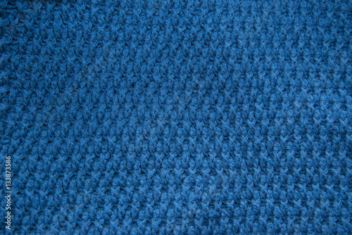 Blue top knitted in manual photographed in close-up.