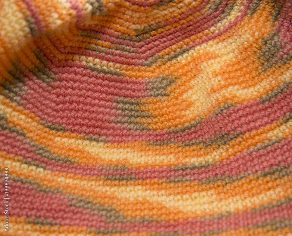 Color sweater knitted in manual photographed in close-up.