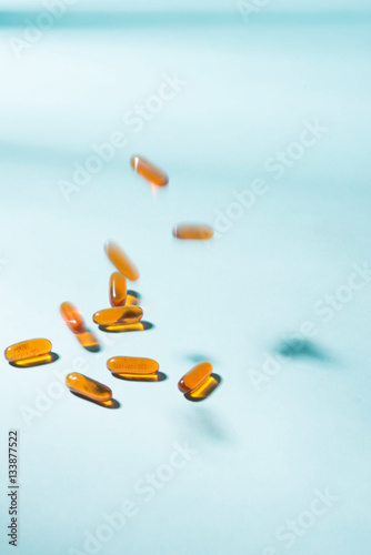 Pills falling down. Gel Capsules.  Vitamin A, E, fish oil, primr photo