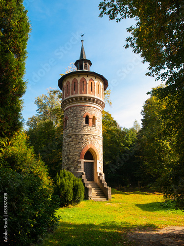 Romantic rounded waterworks tower in the park near Sychrov Castle, Czech Republic, Europe. photo