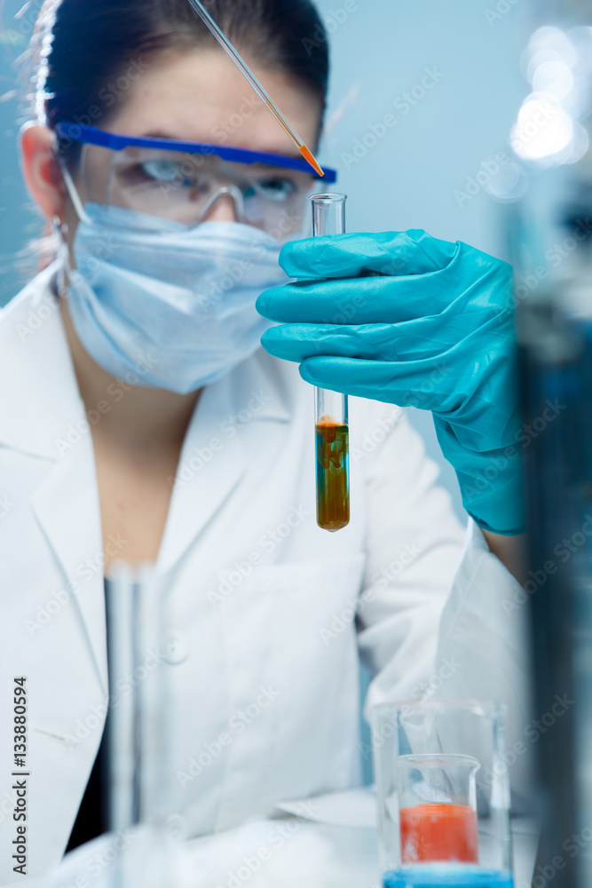 Young researcher handling chemical agents Young researcher handling chemical agents