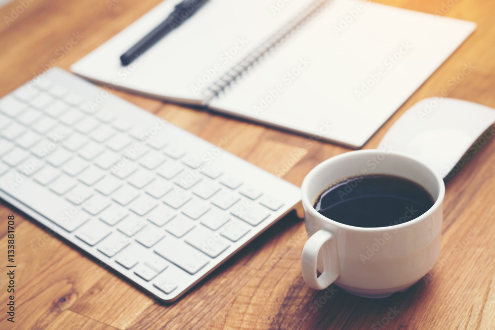 Coffee cup and keyboard computer notebook on wooden table background Coffee cup and keyboard computer notebook on wooden table background