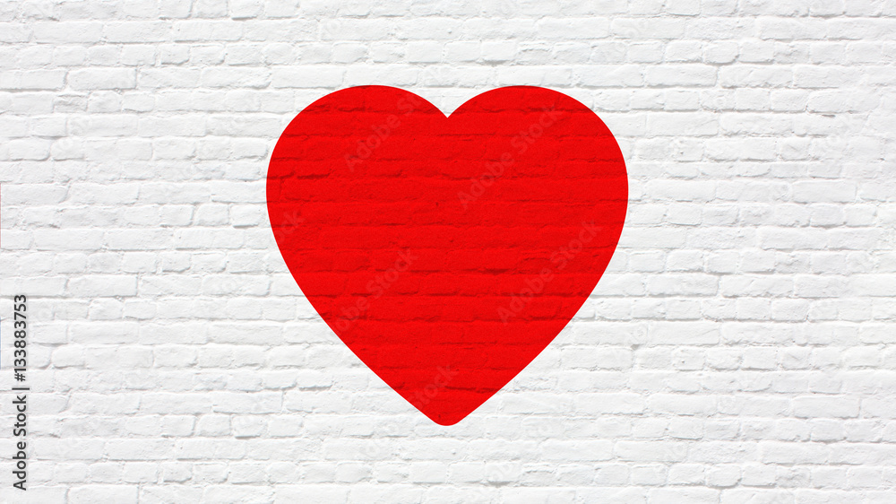 Coeur rouge sur mur de briques