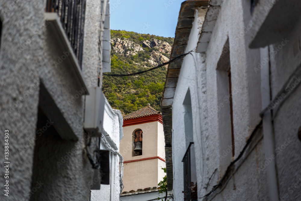 View of a street and a bell tower of a village in the south of S