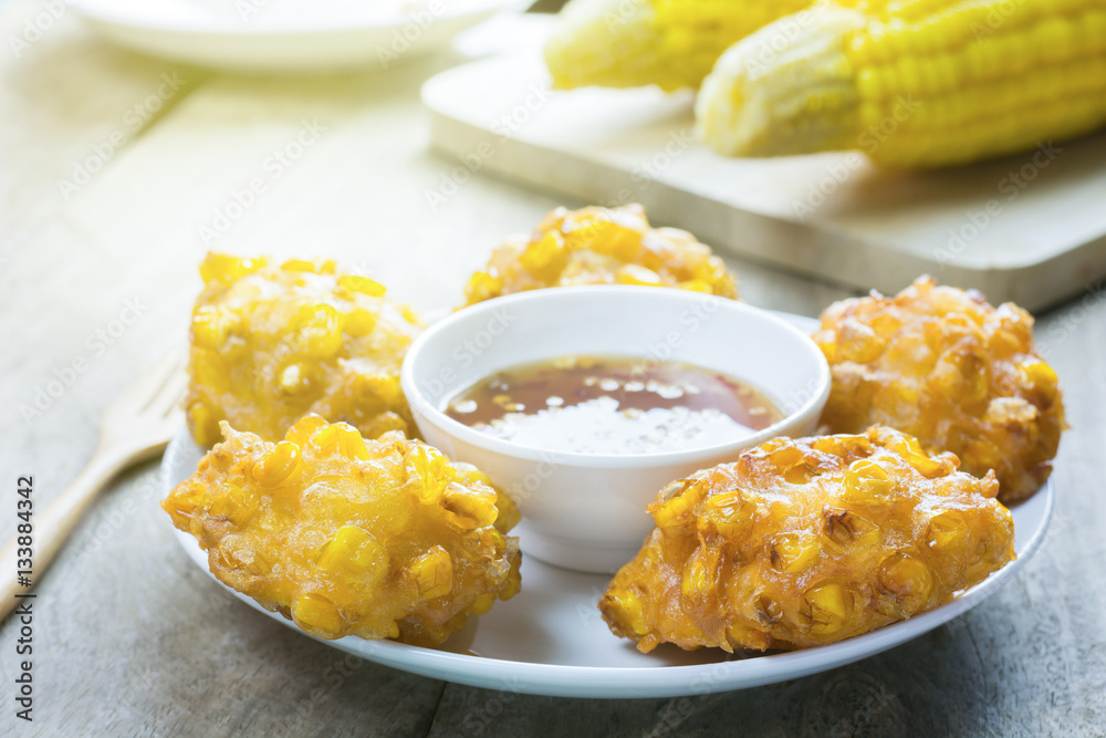 Crispy fried corn ball in a white plate on wooden table,Vegetari Crispy fried corn ball in a white plate on wooden table,Vegetari