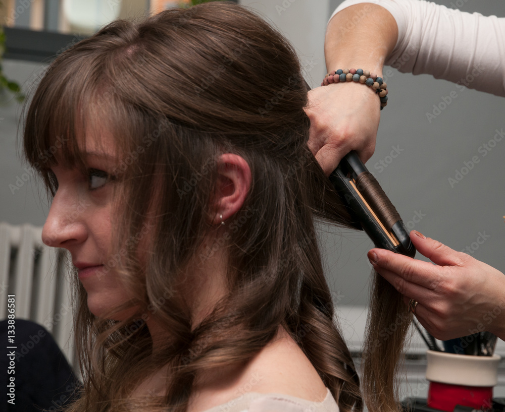 Fototapeta premium Ragazza si arriccia i capelli