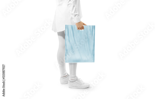 Blank blue plastic bag mockup holding hand. Woman hold plain carrier sac mock up. Polythene bagful branding template. Shopping carry package in persons arm. Promo packet for logotype branding.