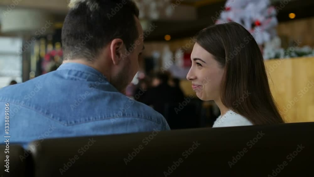 Young happy couple with smartphone in cafe Young happy couple with smartphone in cafe