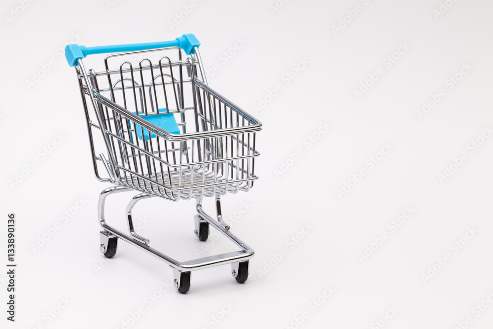 Shopping trolley on the white desk Shopping trolley on the white desk