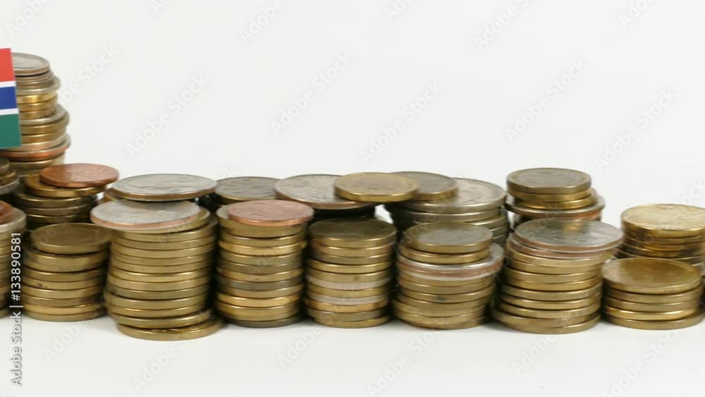 Gambia flag waving with stack of money coins Gambia flag waving with stack of money coins