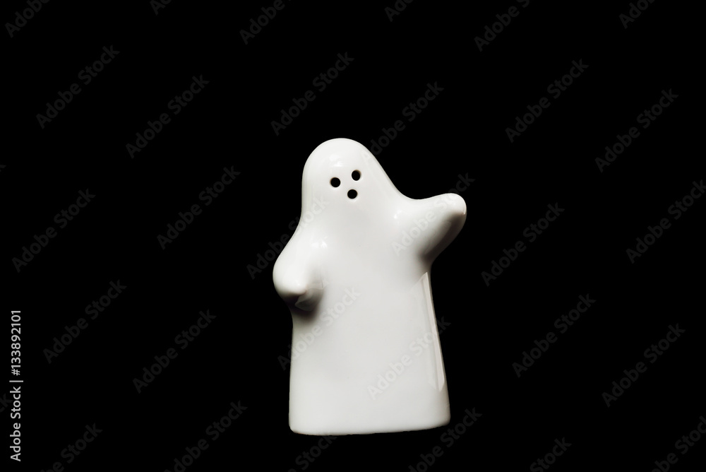 White porcelain figurine on black background White porcelain figurine on black background