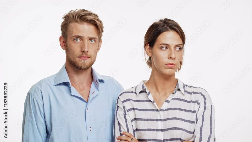 Young Caucasian pair issue. He doesn't know how to say sorry than kisses her. They laughing on white background Young Caucasian pair issue. He doesn't know how to say sorry than kisses her. They laughing on white background
